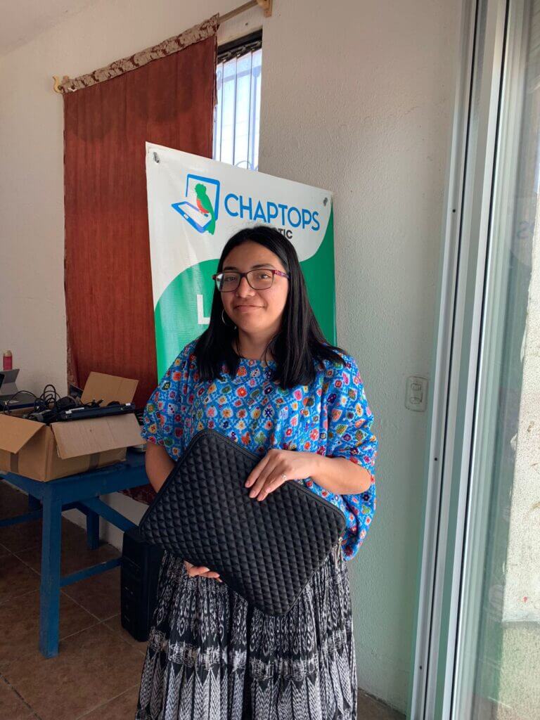 A teacher in traditional indigenous dress who has rented a computer from Chaptops in Tactic, Guatemala.