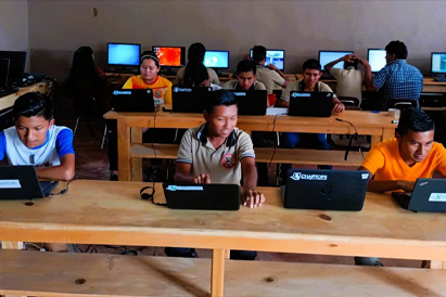 Ten teenagers using Chaptops computers in a computer lab in a rural indigenous school in Alta Verapaz, Guatemala.
